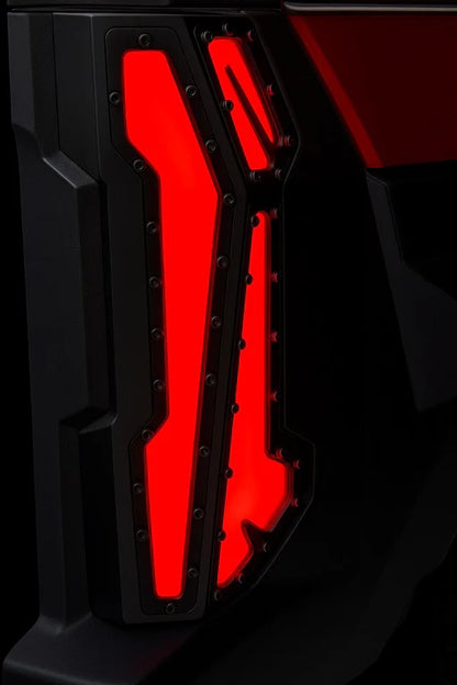 Close-up of a vehicle's red taillight with a black background