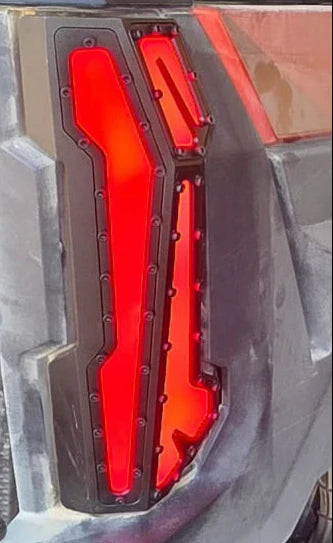 Red car taillight with black casing on a vehicle