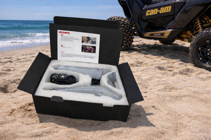 Product packaging on a beach with a Can-Am vehicle in the background