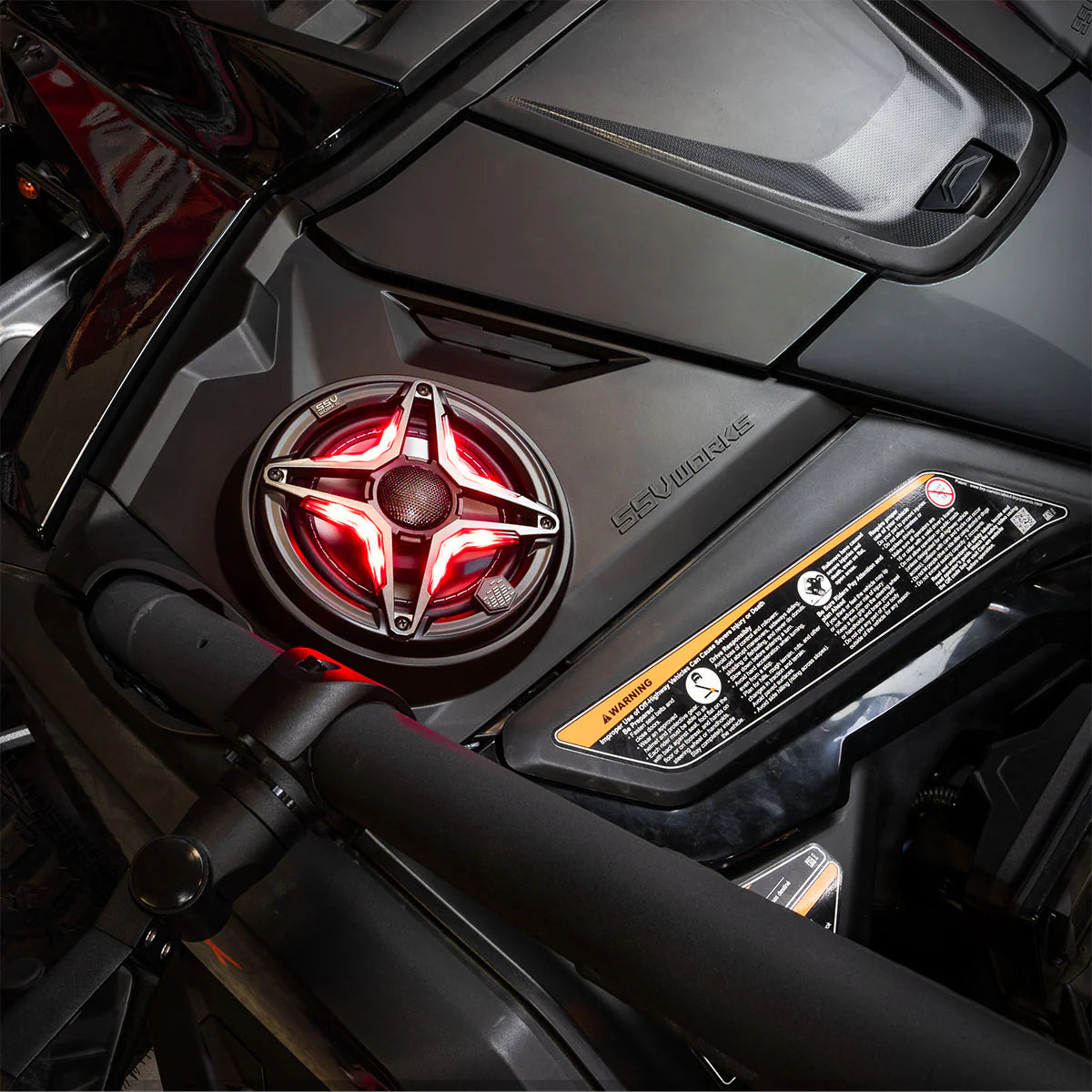 Close-up of a motorcycle's engine cover with a red light and brand logo.