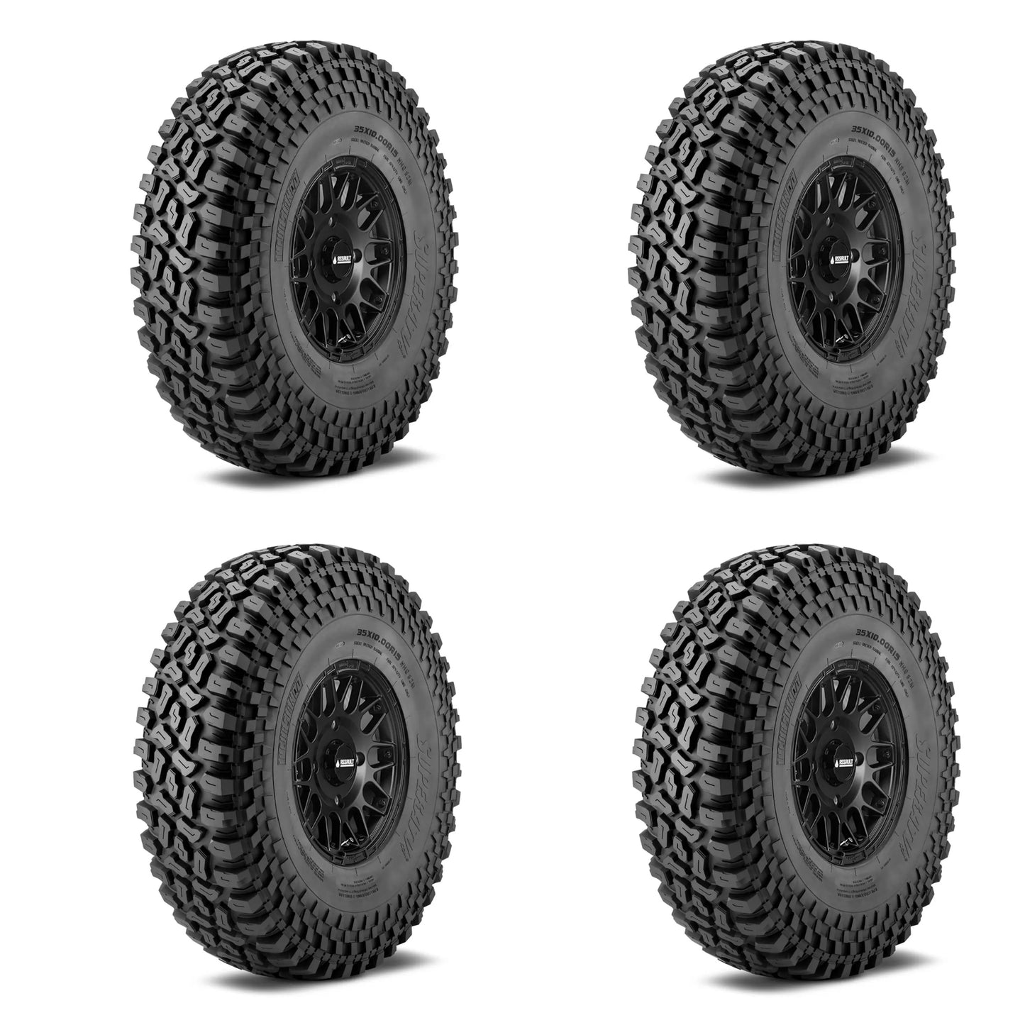 Four black off-road tires with tread patterns on a white background