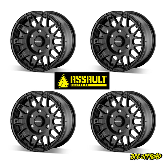 Four black off-road wheels with Assault Industries logo on a white background