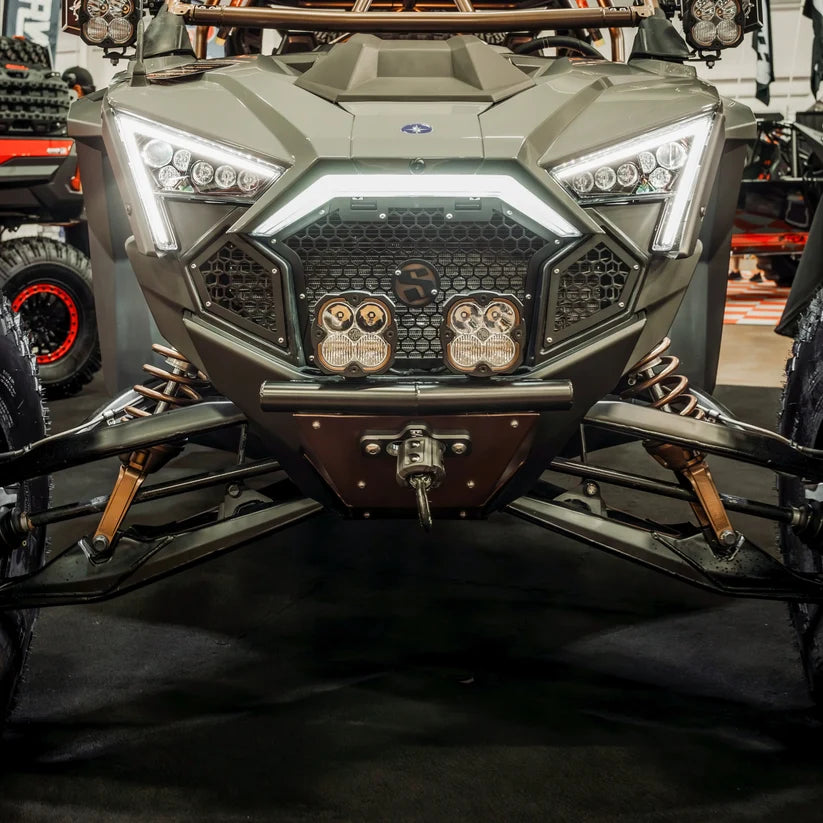 Front view of a military-style vehicle with a prominent grille and headlights.