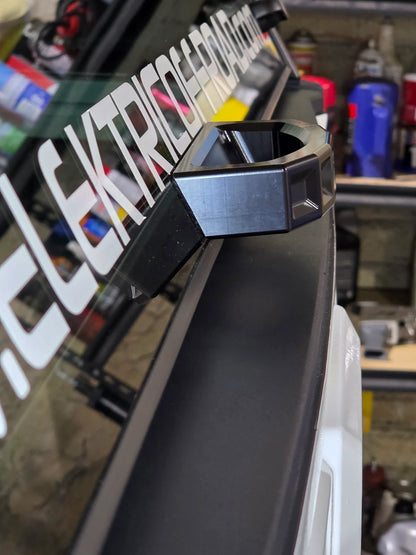 Close-up of a black metal bracket on a vehicle in a workshop setting