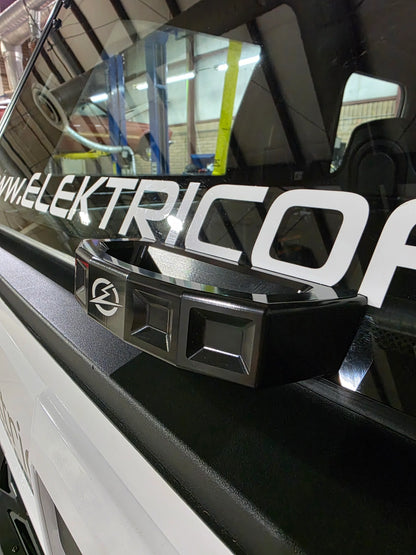Close-up of a vehicle with 'Elektric' branding on a reflective surface.