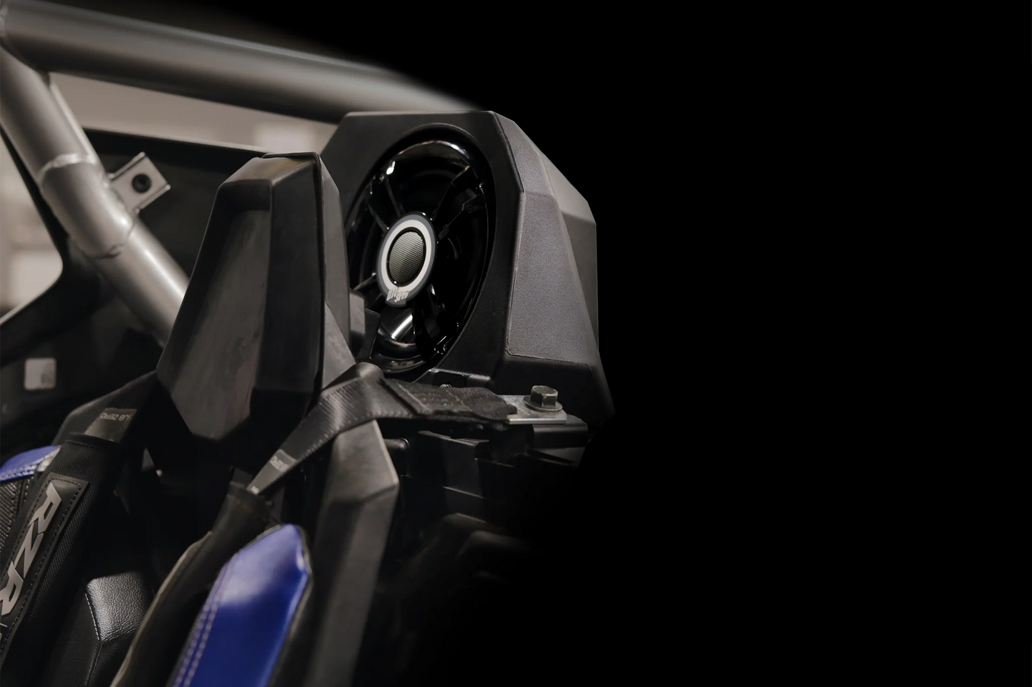 Close-up of a vehicle's front suspension system with a black background