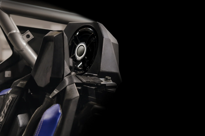Close-up of a vehicle's front suspension system with a black background