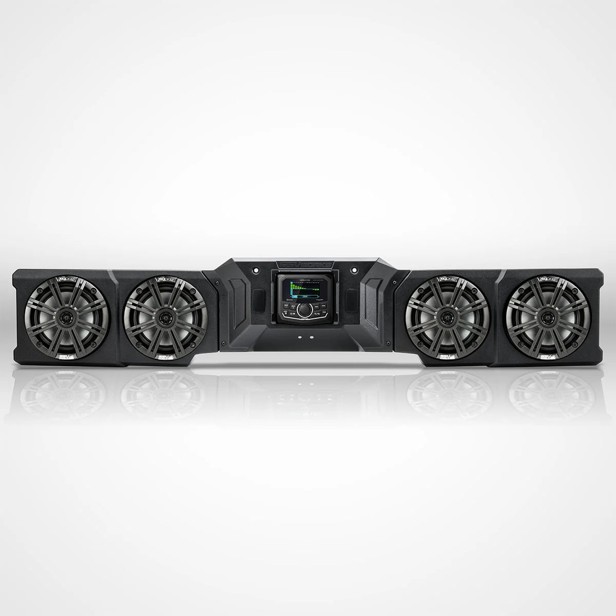 A black multi-subwoofer home theater speaker system with four large woofers and a central control screen, shown on a reflective white studio background.