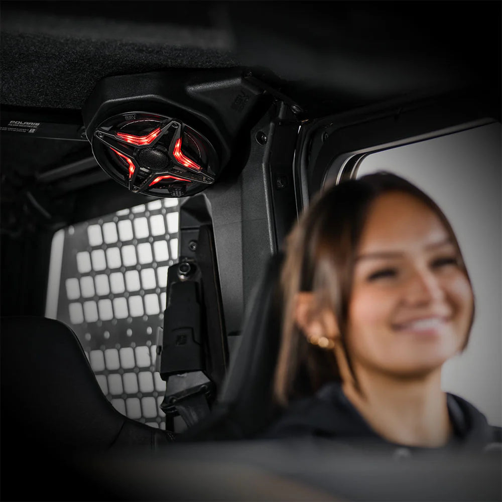 Person sitting inside a vehicle with a red light on the ceiling