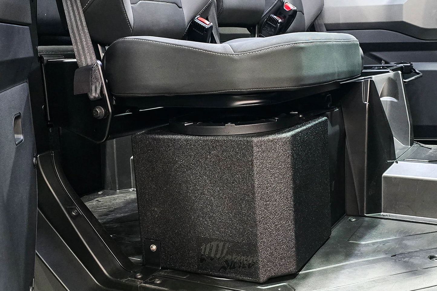 Black storage box under a folded seat in a vehicle interior