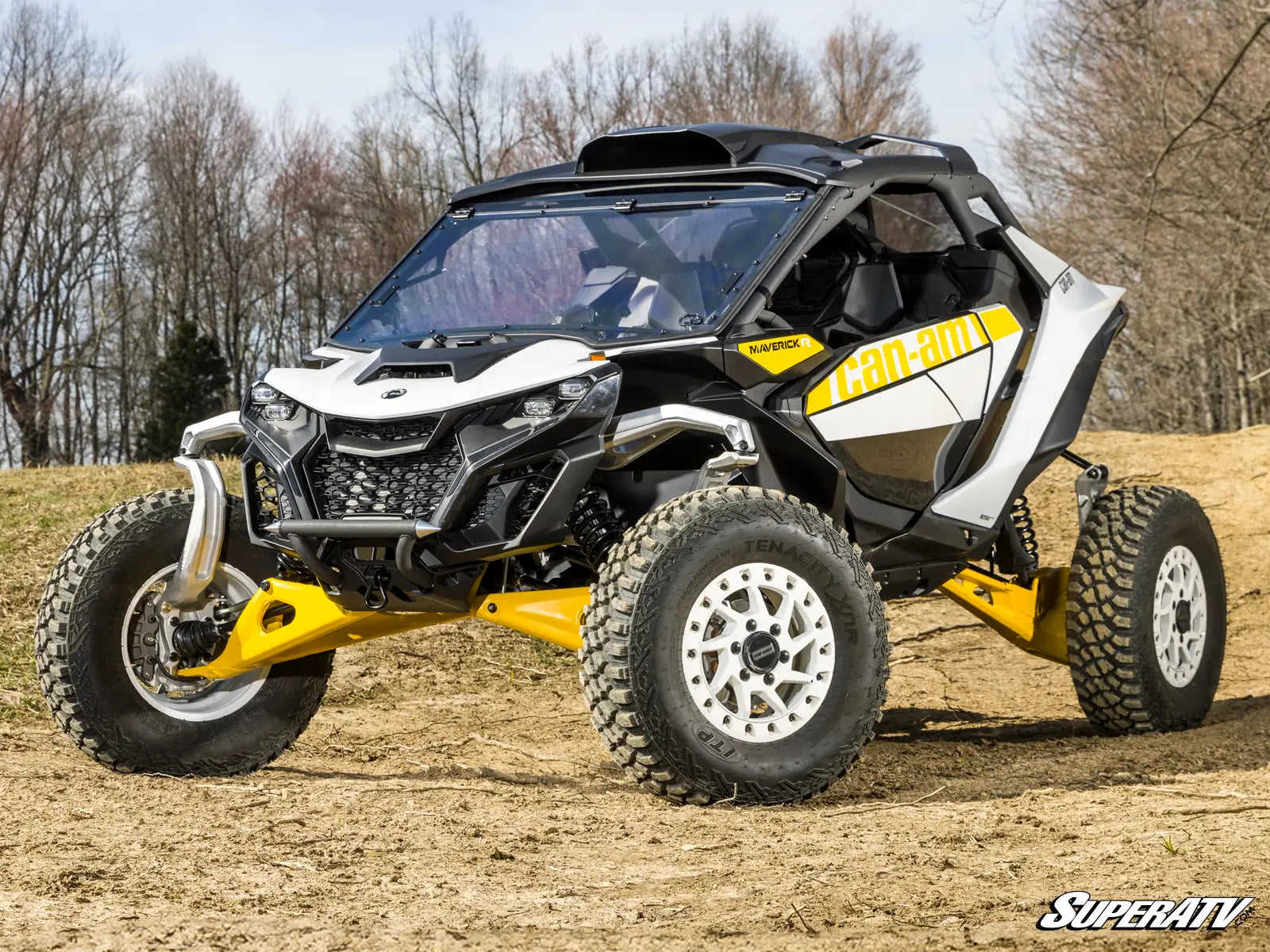 Can-Am Maverick X3 side-by-side vehicle on a dirt path with trees in the background