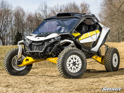 Can-Am Maverick X3 side-by-side vehicle on a dirt path with trees in the background