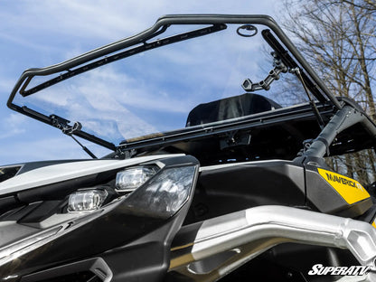 Close-up of a SuperATV windshield on an off-road vehicle with a clear sky background.