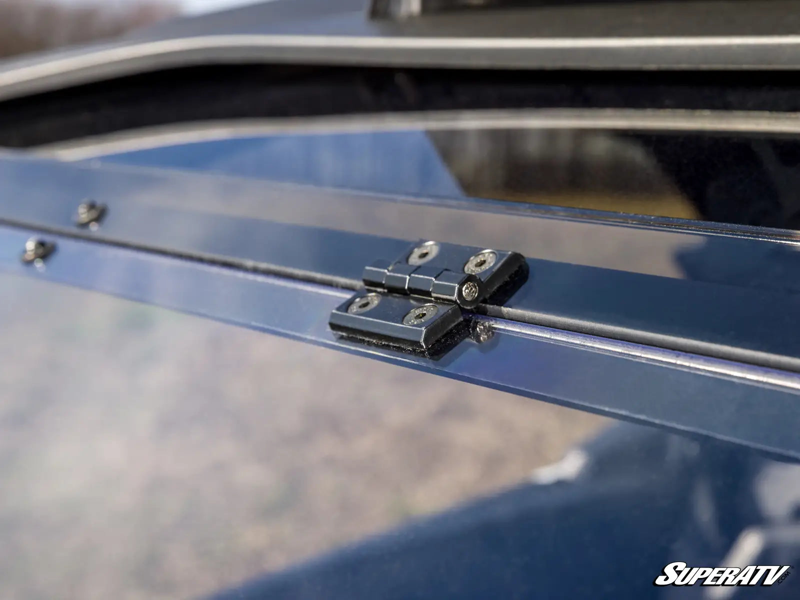 Close-up of a SuperATV product on a vehicle, focusing on the hinge mechanism.