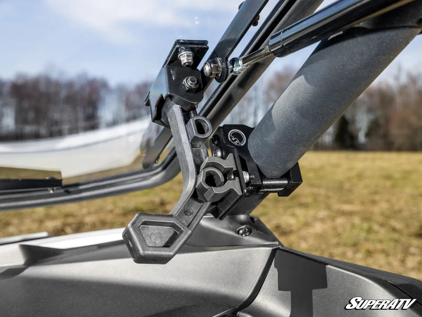 Close-up of a SuperATV product with a blurred outdoor background