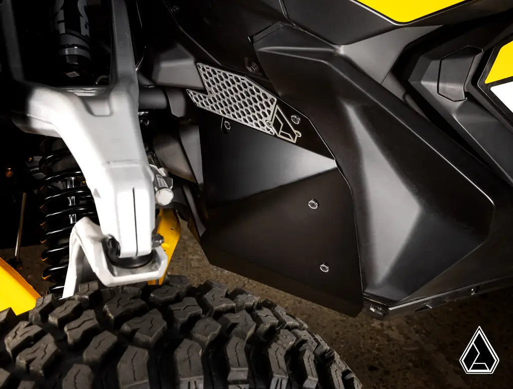 Close-up of a motorcycle's suspension and fender on a textured surface