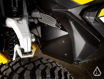 Close-up of a motorcycle's suspension and fender on a textured surface