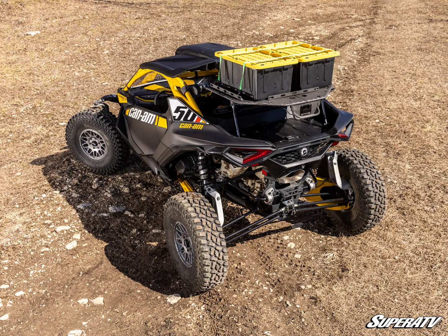 Black and yellow off-road vehicle on a dirt surface with 'SuperATV' branding.
