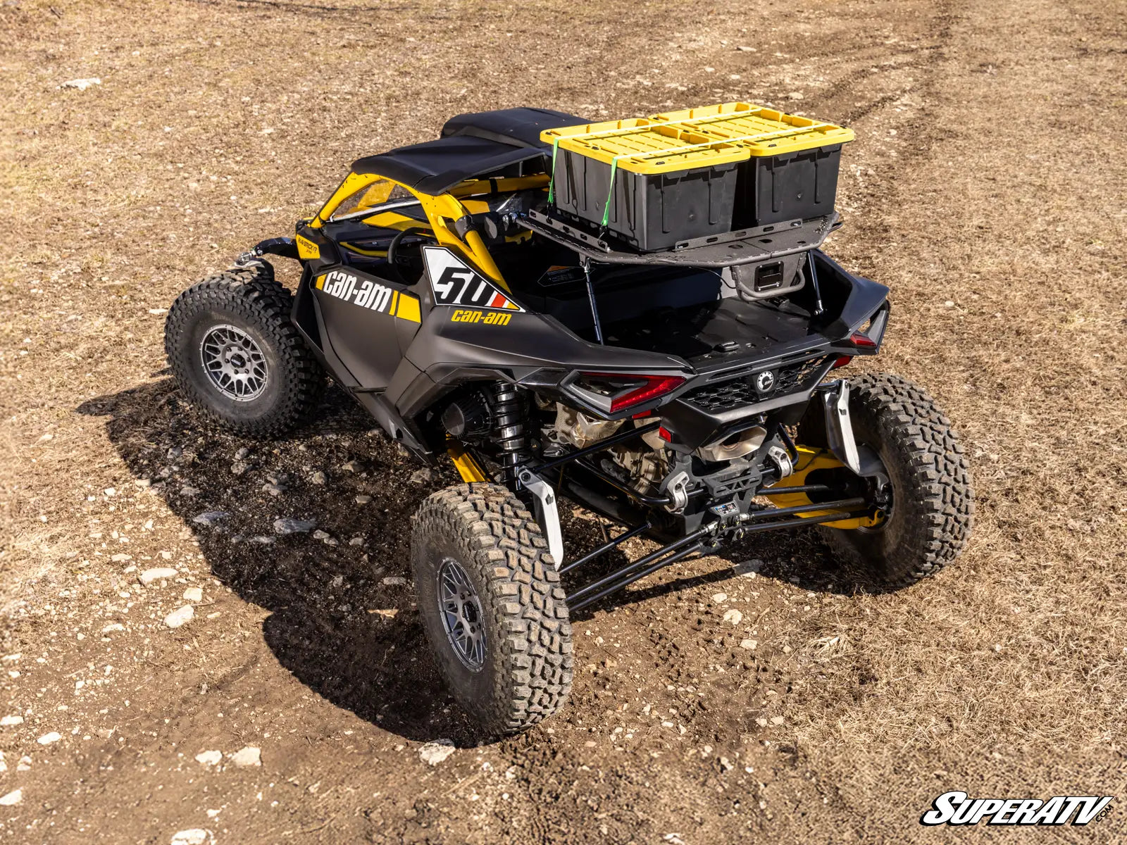 Black and yellow off-road vehicle on a dirt surface with 'SuperATV' branding.