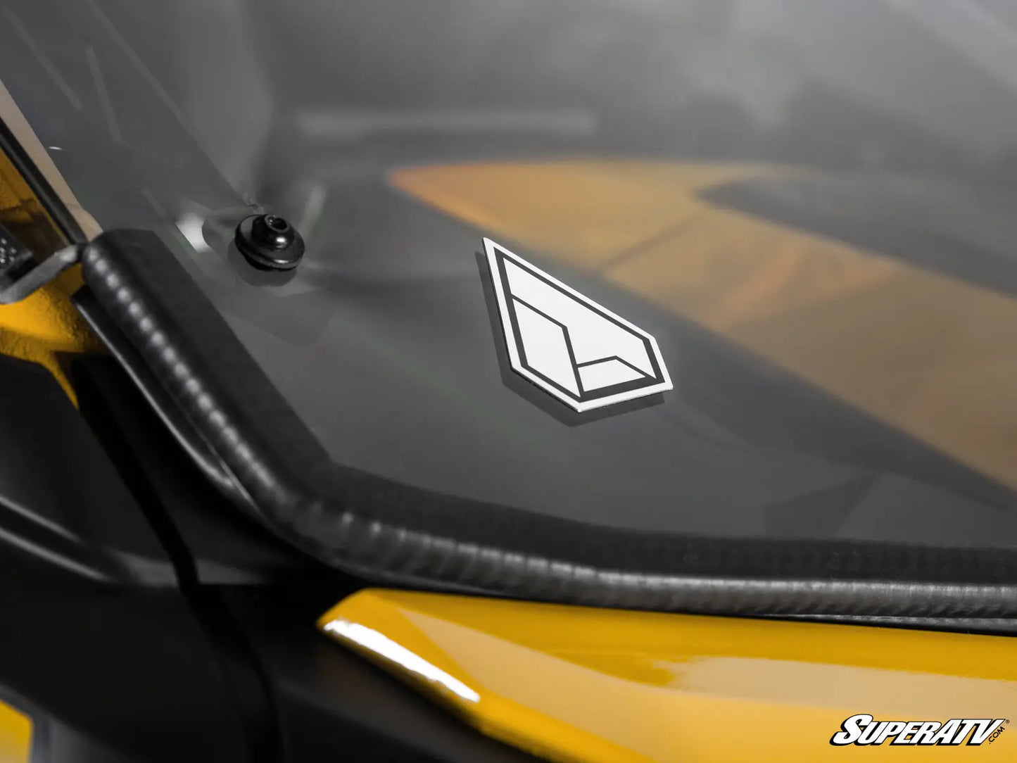 Close-up of a SuperATV logo on a vehicle's side panel.