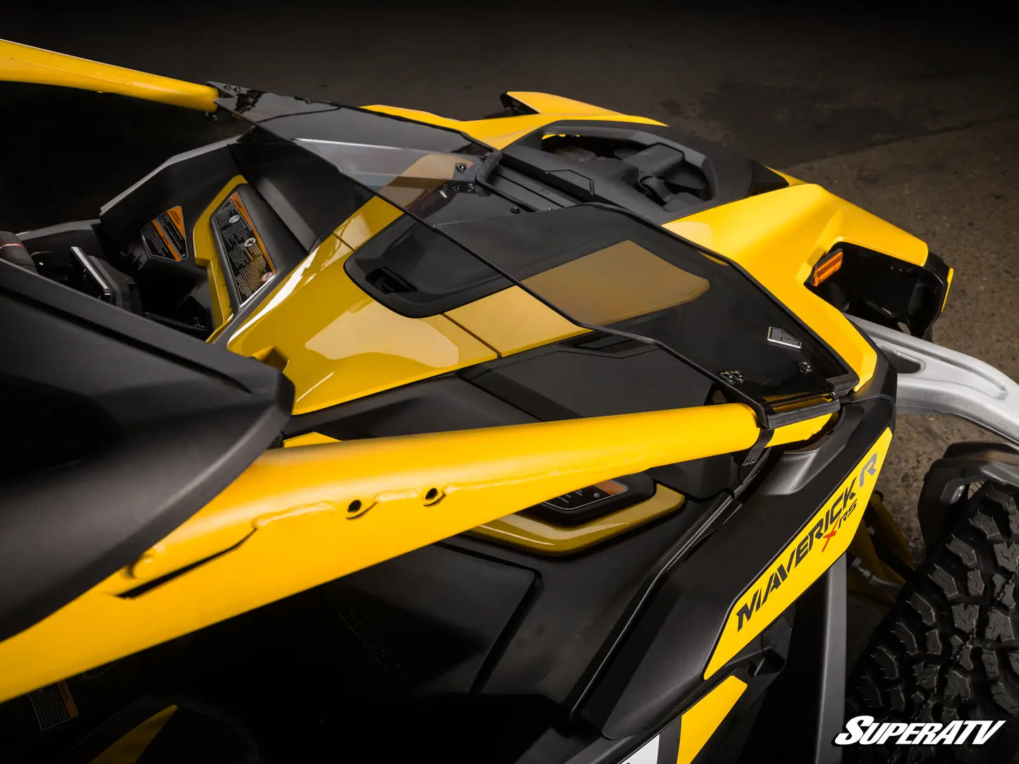 Close-up of a yellow and black SuperATV vehicle on a dark background
