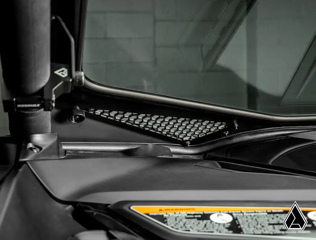 Close-up of a vehicle's interior dashboard with a steering wheel and instrument panel.