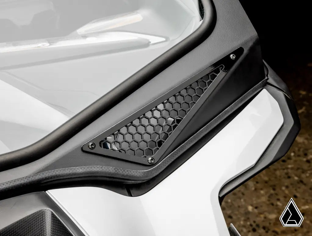 Close-up of a vehicle's front grille with honeycomb pattern