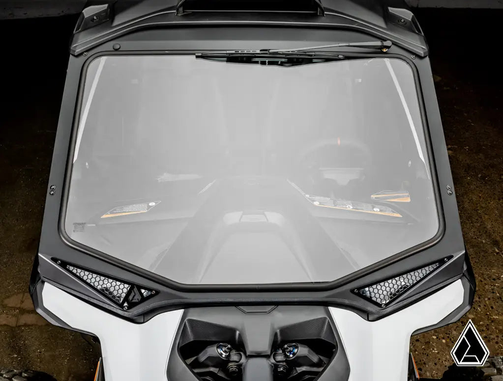 Close-up of a motorcycle windshield with a dark background