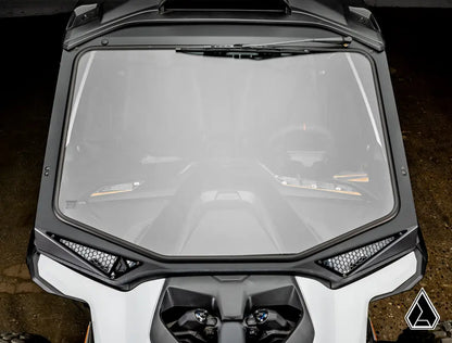 Close-up of a motorcycle windshield with a dark background