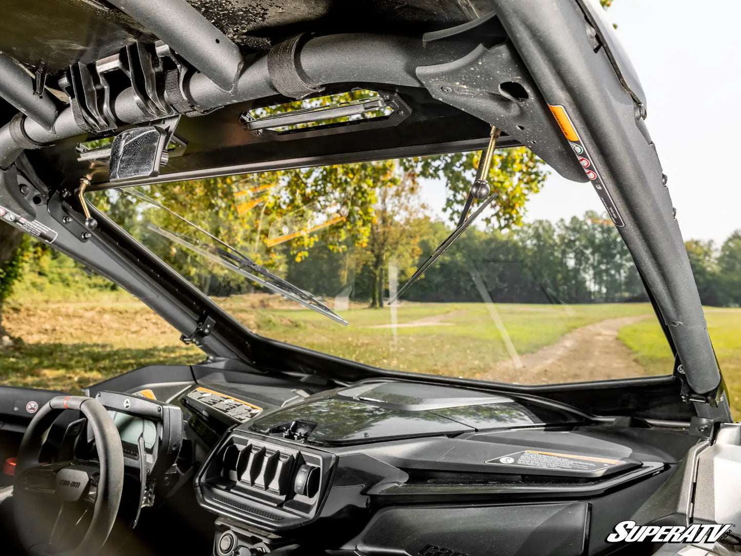 Close-up of a vehicle's windshield and dashboard with a scenic background