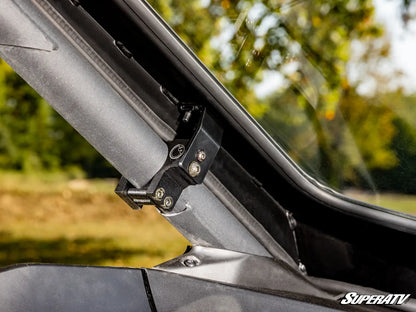 Close-up of a vehicle's roof rack system with a blurred natural background