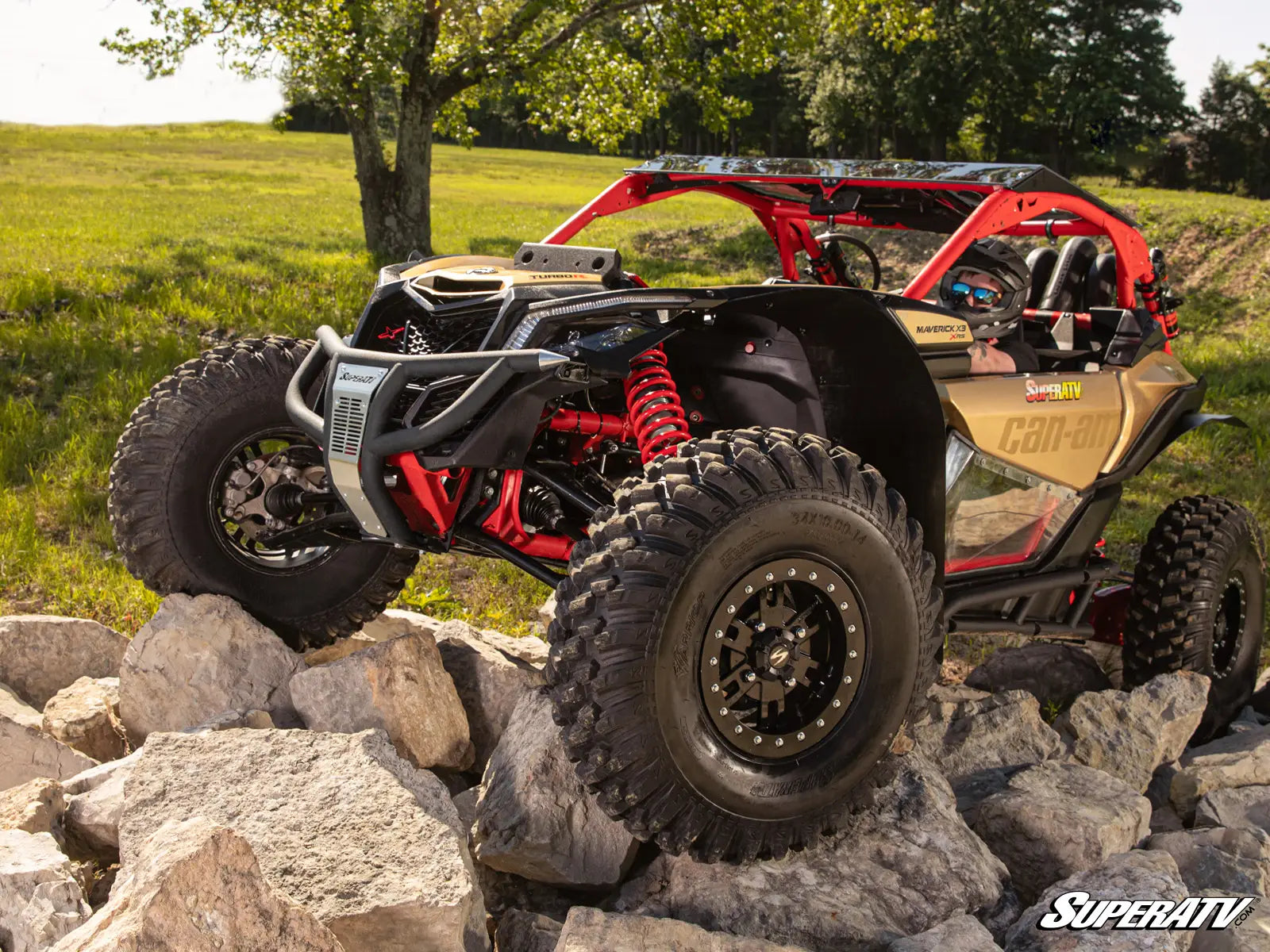 Off-road vehicle on rocks with a scenic background
