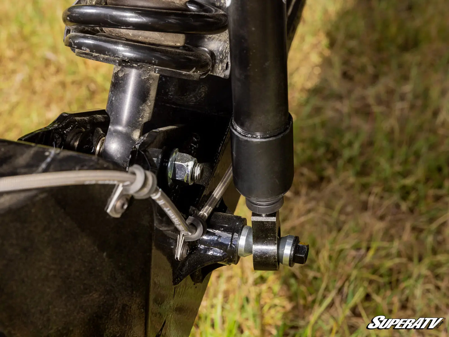 Close-up of a suspension system on a vehicle with 'SuperATV' branding.
