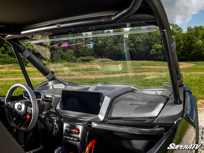 Close-up of a SuperATV vehicle interior with dashboard and steering wheel.
