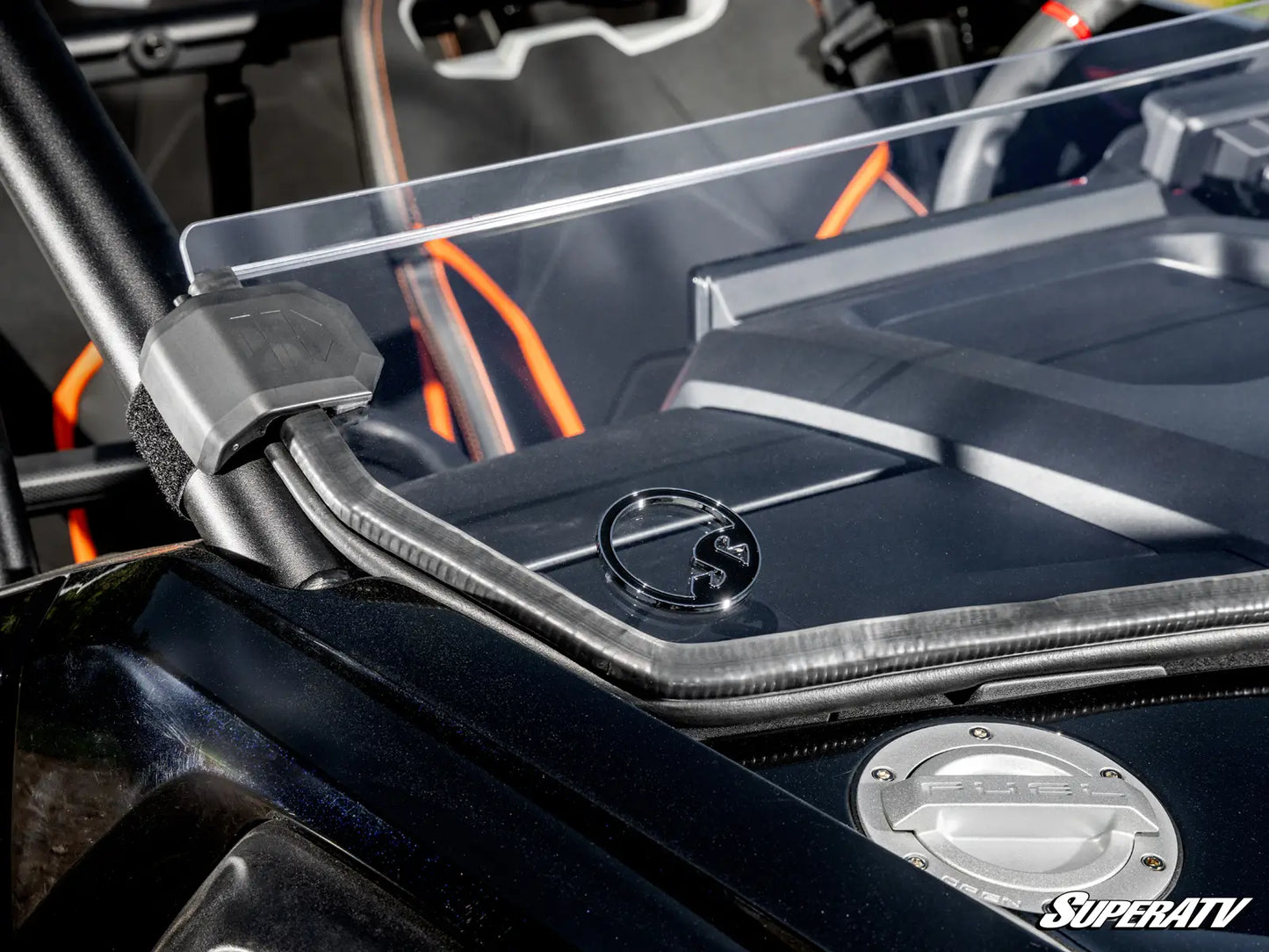 Close-up of a SuperATV branded vehicle with clear protective cover on a black background