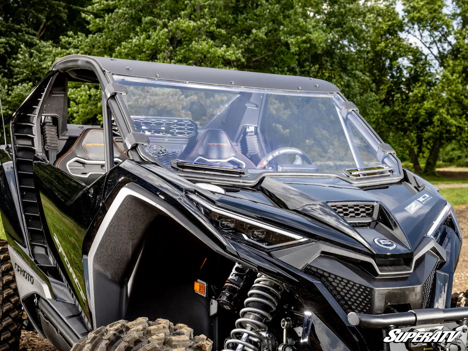 Black off-road vehicle with a clear windshield in a forest setting