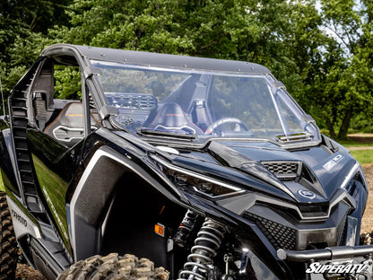 Black off-road vehicle with a clear windshield in a forest setting