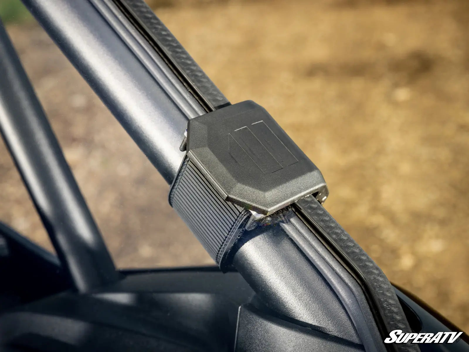 Close-up of a metal bracket on a SuperATV product with a blurred background