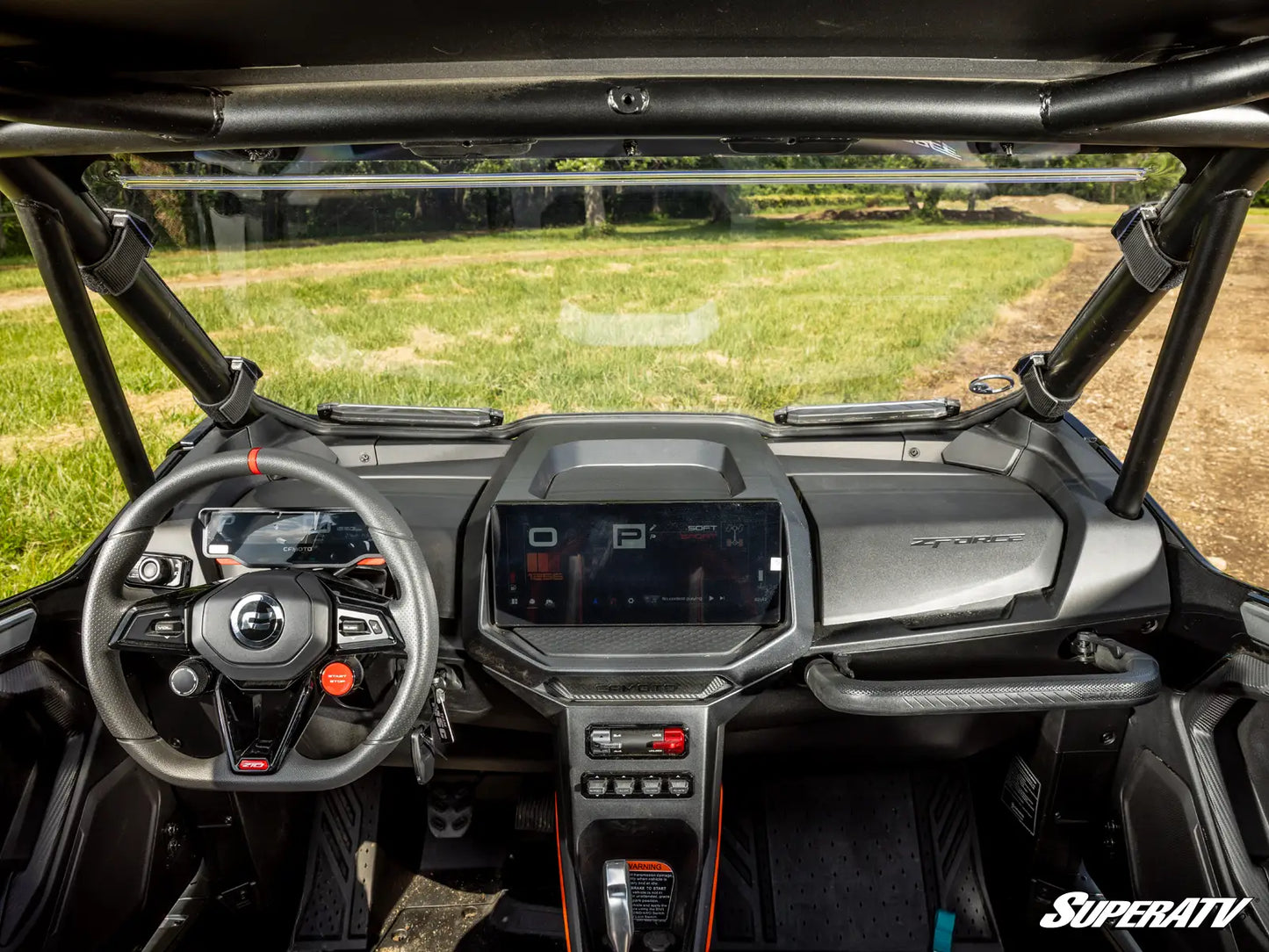 Interior of a SuperATV vehicle with dashboard and steering wheel.