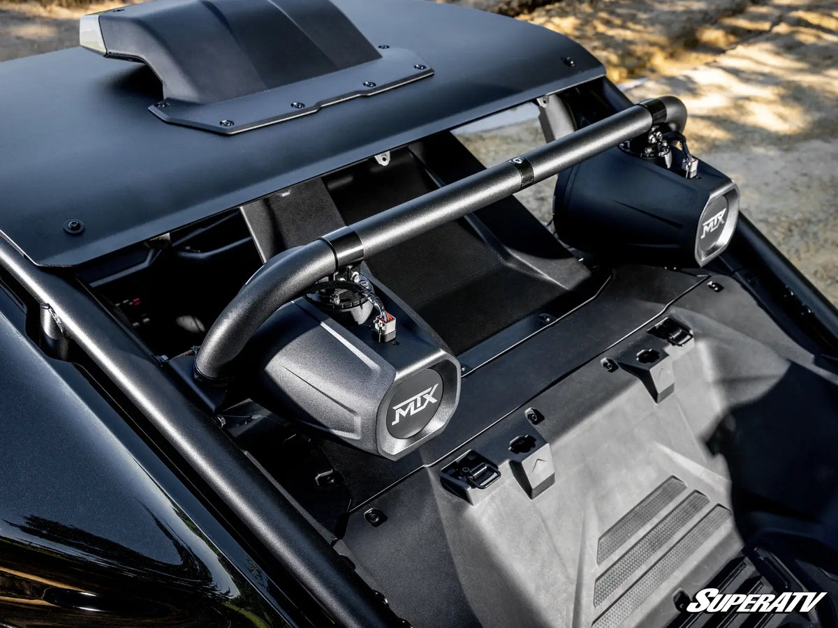 Close-up of a black off-road vehicle roll bar and side mirrors with 'MIX' branding, installed in a vehicle cabin with a gravel background.