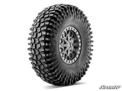 Off-road tire with detailed tread pattern on a white background, featuring the SuperATV logo.