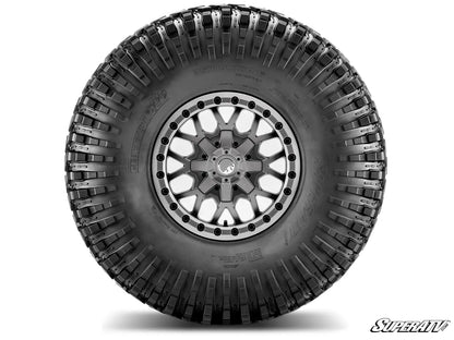 Tire with tread pattern on a white background, featuring the SuperATV logo.