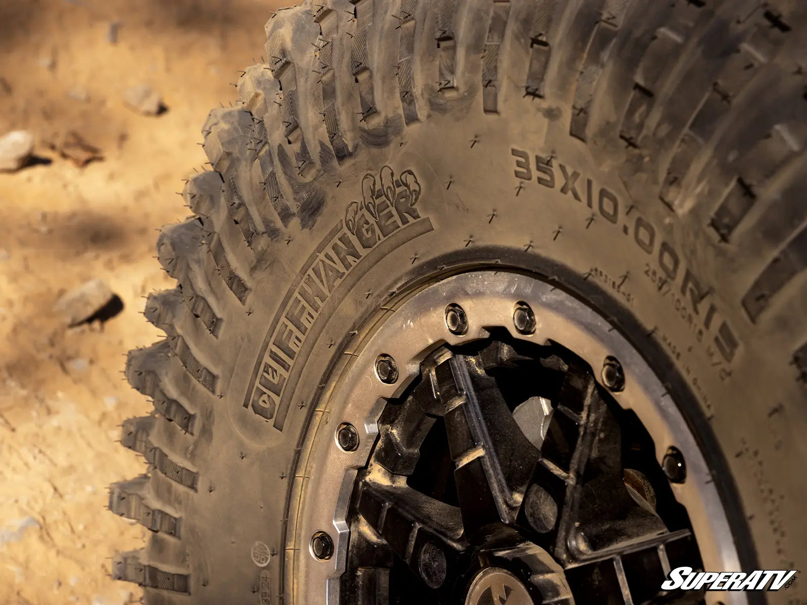 Close-up of a SuperATV tire with tread pattern and branding.