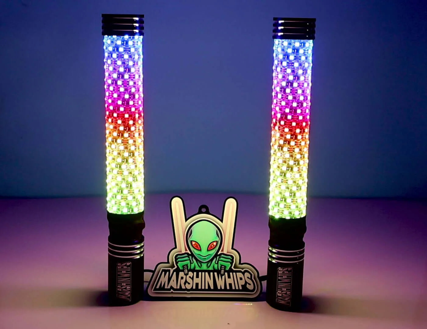 Two colorful marshin whips with a Marshin Whips logo in the center on a gradient background.