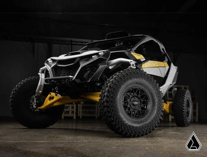 Side view of a black and yellow off-road vehicle in a dark setting