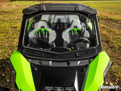 Green and black SuperATV vehicle with open top in a field