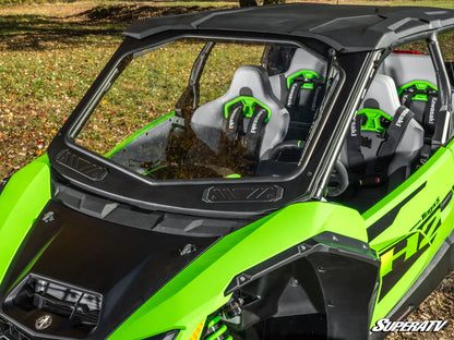 Green and black side-by-side vehicle with seats and SuperATV branding.