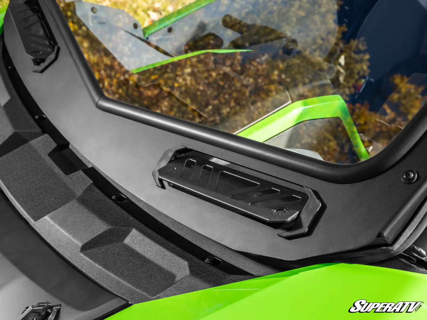 Close-up of a green and black ATV with a SuperATV logo.