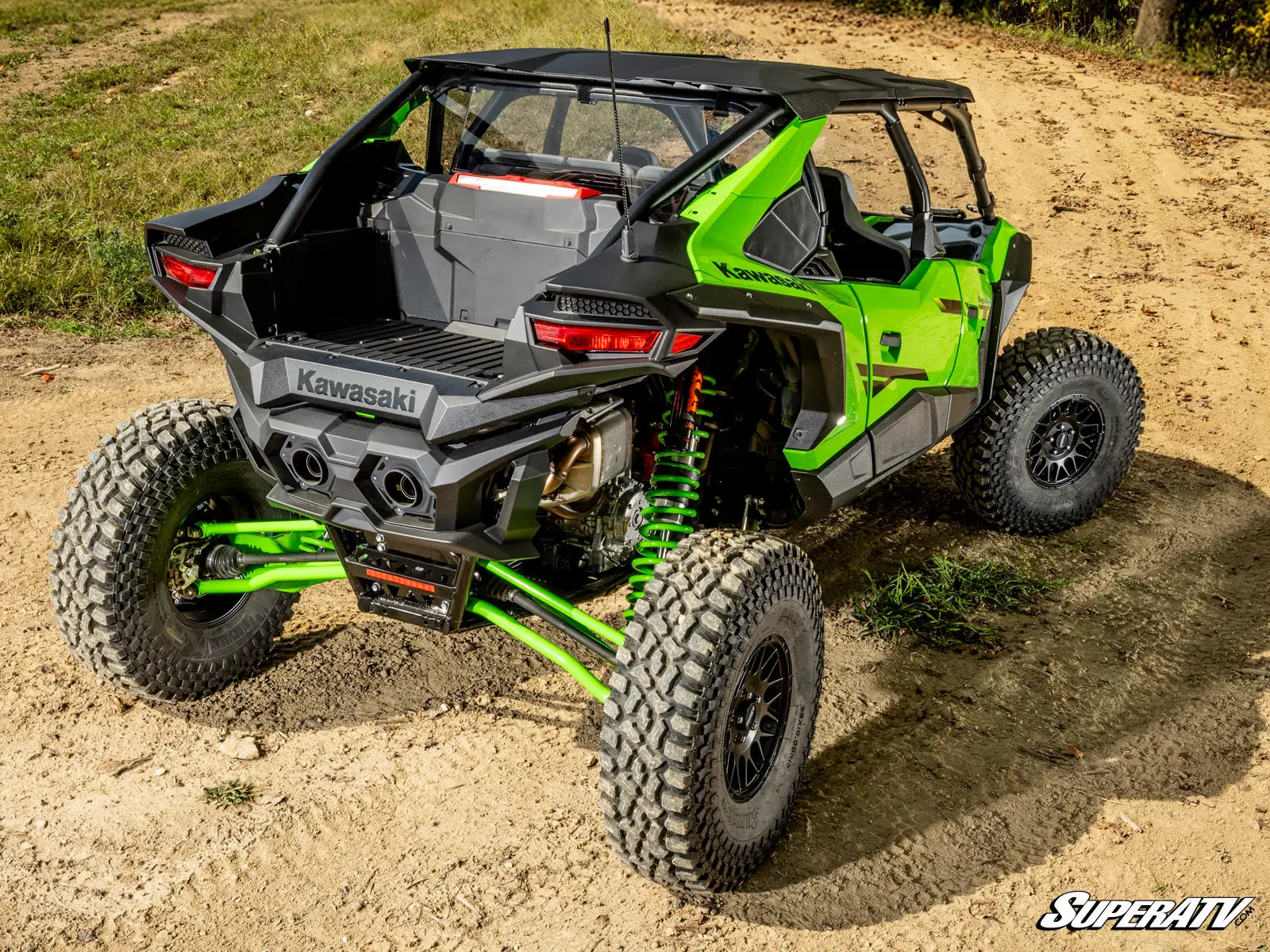 Green Kawasaki off-road vehicle on a dirt path