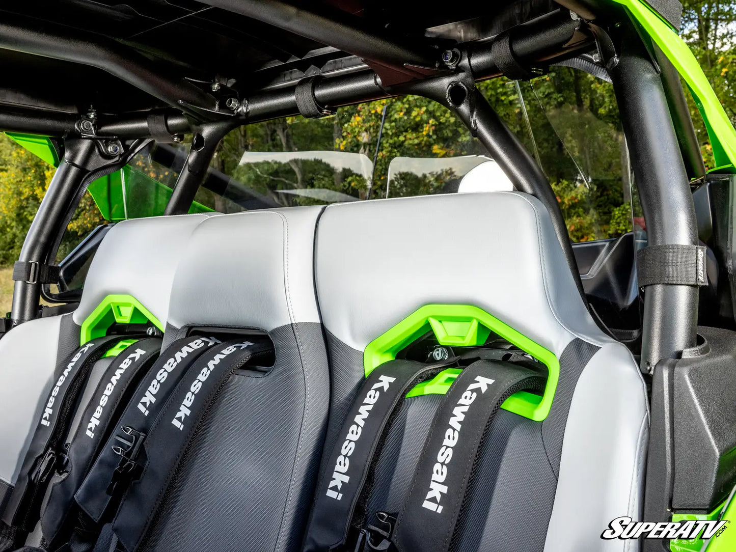 Gray and green seats of a Kawasaki vehicle with visible branding.